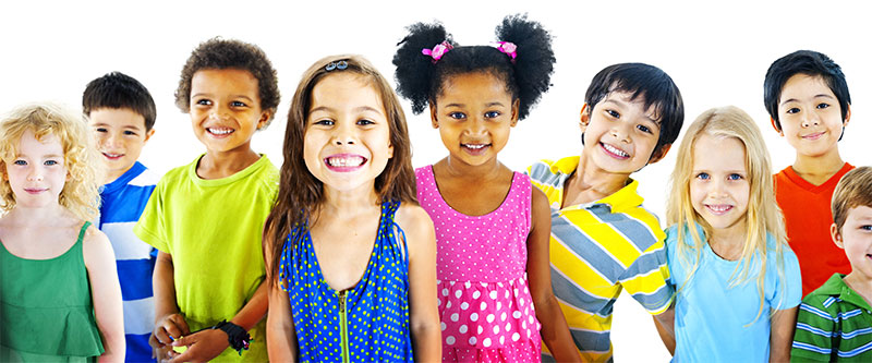 The image shows a group of diverse children smiling at the camera, with varying skin tones and hairstyles, wearing colorful clothing, posing for a photograph.