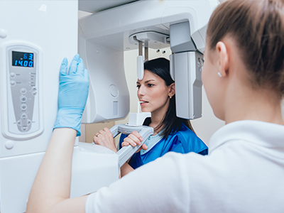 An image featuring two individuals with a 3D scanner, likely in a medical or dental setting.