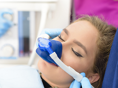 A woman receiving oxygen therapy with medical equipment.